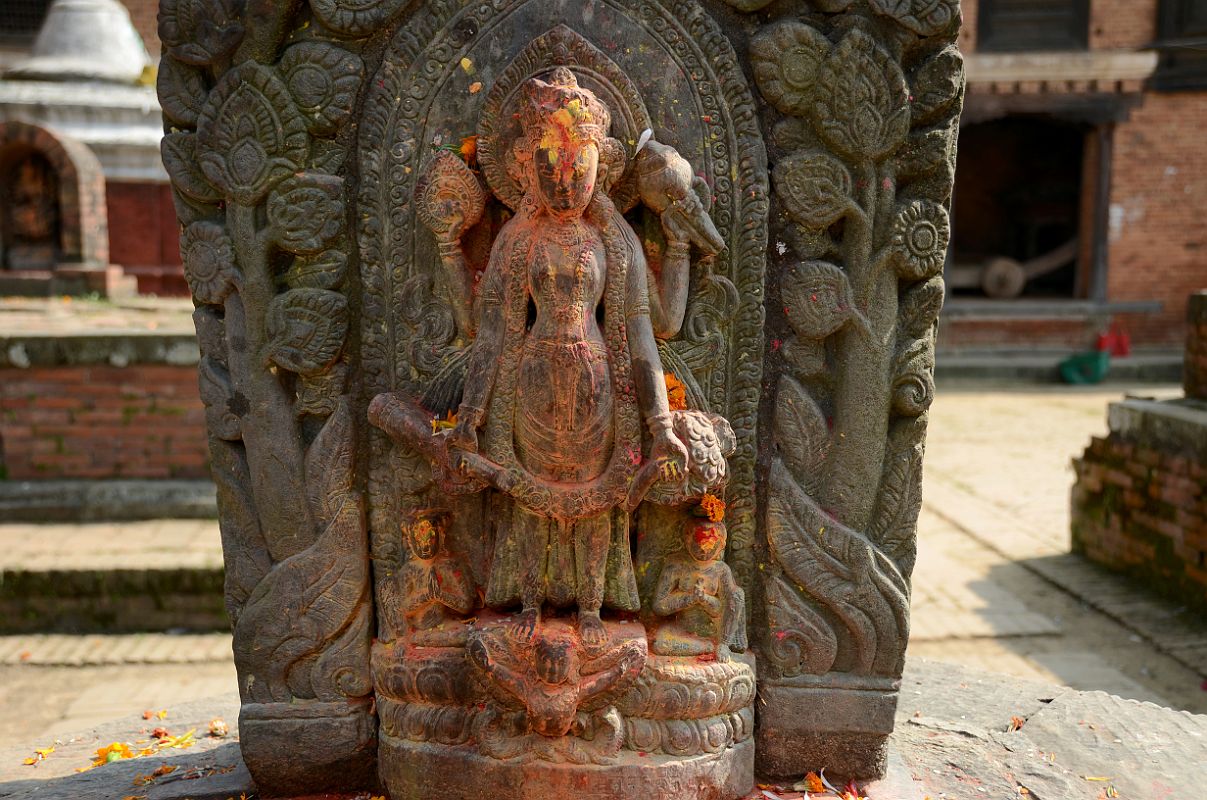 Kathmandu Changu Narayan 30 Four Armed Vishnu Stands On Garuda Behind A Headless Statue In The North East Corner Of Changu Narayan A four armed Vishnu stands on Garuda in the north east corner of Changu Narayan. Vishnu arms hold the disc, mace / club, conch shell, and lotus.